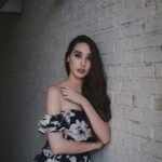Elegant black and white floral dress with flowing design, paired with minimal accessories for modern fashion look