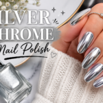 Elegant close-up of hands with silver chrome nail polish featuring a mirror-like metallic shine and smooth, glossy manicure finish.