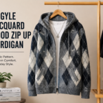 Argyle jacquard hood zip up cardigan displayed on a wooden hanger in a modern studio fashion setup with neutral background