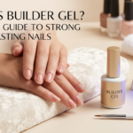 Close-up of glossy, natural-looking manicured nails resting on a salon armrest next to a gold builder gel bottle and a UV LED nail lamp.