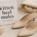 Elegant minimal flat lay featuring stylish kitten heel mules with soft neutral tones, showcasing kitten heel mules as a timeless fashion footwear choice.
